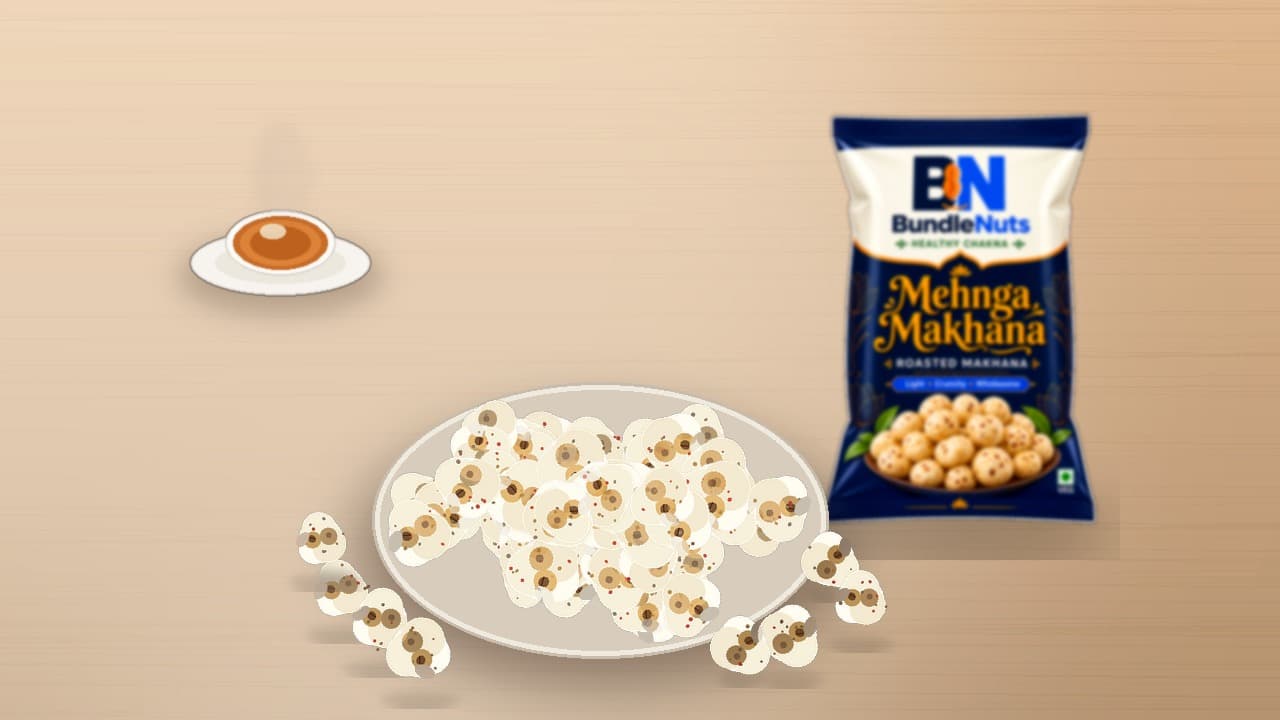 Golden roasted makhana kernels in a serving bowl on a wooden desk with a BundleNuts Makhana pouch softly in the background.