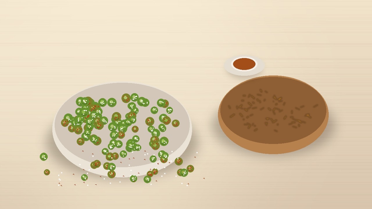 A ceramic bowl filled with golden-green dry-roasted peas on a warm wooden tabletop beside a hot cup of tea, with a softly blurred bowl of fried namkeen in the background.