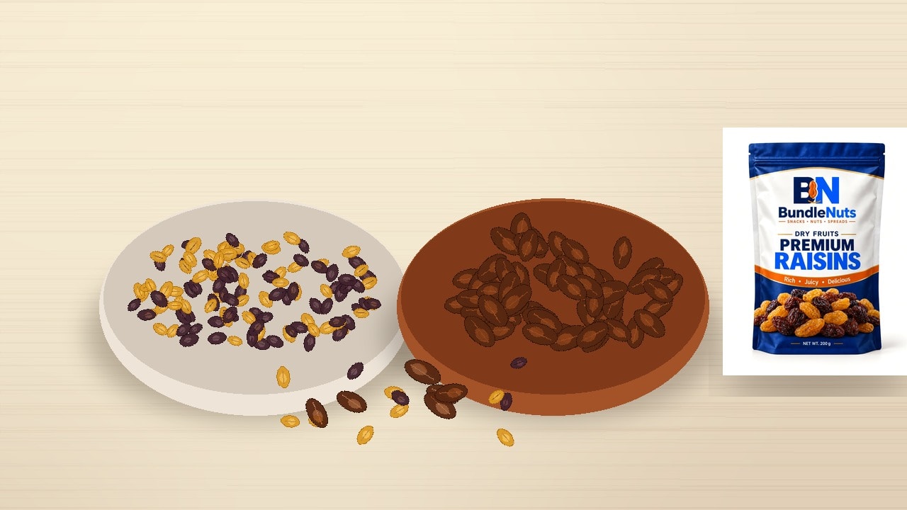 A cream ceramic bowl filled with dark seedless raisins and golden sultanas on the left and a terracotta bowl of whole pitted amber dates on the right, arranged on a warm wooden tabletop with scattered dried fruits.