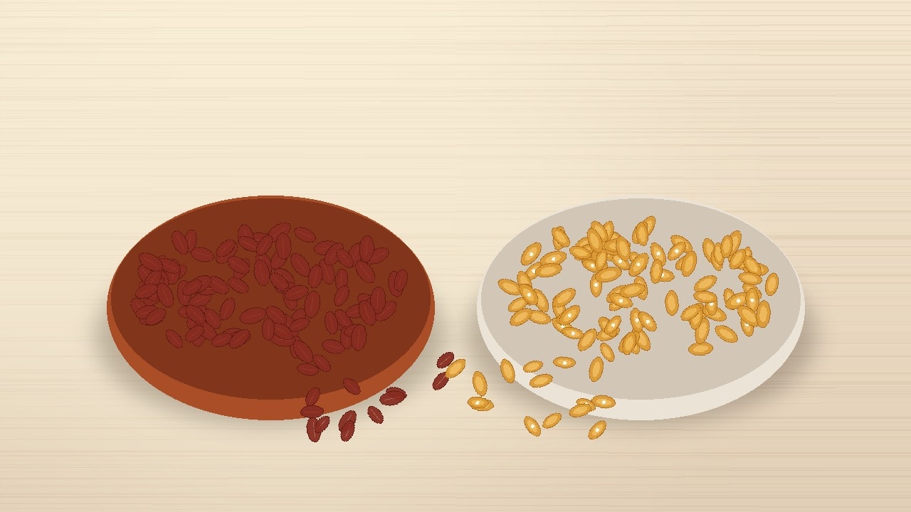 A rustic terracotta bowl of dark red raw peanuts on the left and a cream ceramic bowl of golden dry-roasted peanuts on the right, arranged on a warm wooden tabletop with scattered peanut kernels.